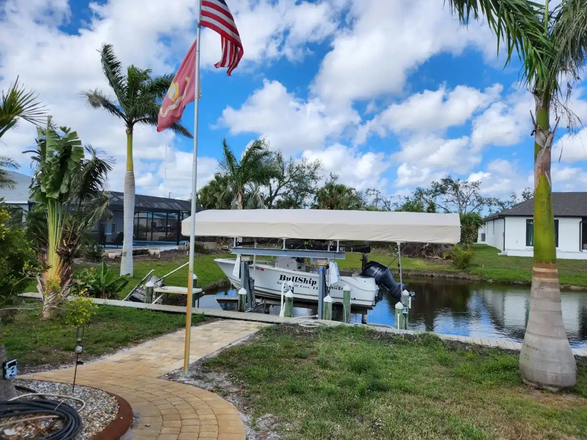 Covered boat lift with a pontoon boat docked underneath.